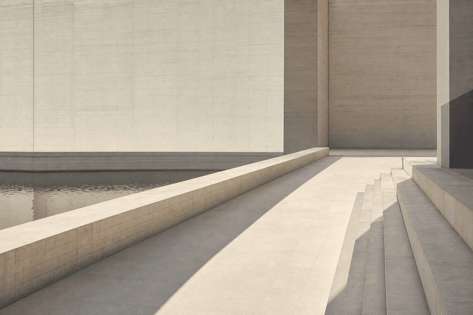 Broad stone steps running down beside a still channel of water, against a tall board-marked concrete wall.
